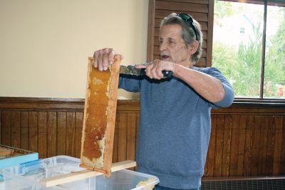 Bee Talk
Local cranberry grower and beekeeper Paul Rinta demonstrated honey extraction during a presentation on the plight of bees in North America given by his wife and business partner Linda Rinta, a local bee expert and educator. The event was a partnership between the Sippican Land Trust and Marion Garden Group and took place on September 30. Photos by Marilou Newell
