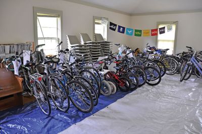 Bikes for All 
Liz DiCarlo and Bill Emmons put the finishing touch, a bell, on two of the 30 bicycles collected by Bikes for All before they are distributed to their new owners on June 19, an effort by the Friends of the Mattapoisett Bicycle and Recreational Path and Mattapoisett Recreation to make sure everyone in Mattapoisett has an opportunity to use the bike path. Photo by Beth David/Fairhaven Neighborhood News
