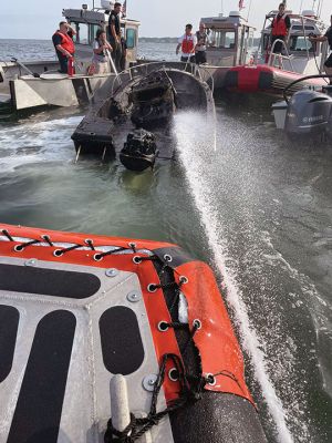 Boat Fire
All passengers escaped without harm after a small boat in Aucoot Cove was swallowed up in flames on July 1. Marion M225 responded to the boat fire, and activation of the Buzzards Bay Task Force followed. Marion Assistant Harbormaster David Wilson can be seen dousing the flames with assistance from the Mattapoisett, New Bedford and Wareham fire departments, Mattapoisett Harbormaster and New Bedford Police. Photos courtesy Marion Fire Department
