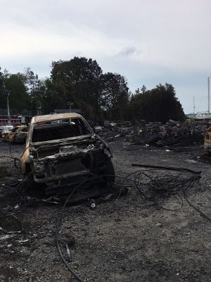 Mattapoisett Boatyard Fire
Smoke rose over Mattapoisett Harbor on August 19 after a boat caught fire during the replacement of a gasoline tank. An explosion followed by a raging fire leveled Mattapoisett Boatyard and destroyed the 14 boats and 47 vehicles on site. Members of the Kaiser family who own the business and members of the McLean family who founded the business surveyed the ruins on the weekend and vow to rebuild. Photos by Marilou Newell and courtesy of Mattapoisett Police and Fire departments and Kathleen Costello
