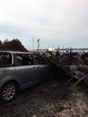 Mattapoisett Boatyard Fire
Smoke rose over Mattapoisett Harbor on August 19 after a boat caught fire during the replacement of a gasoline tank. An explosion followed by a raging fire leveled Mattapoisett Boatyard and destroyed the 14 boats and 47 vehicles on site. Members of the Kaiser family who own the business and members of the McLean family who founded the business surveyed the ruins on the weekend and vow to rebuild. Photos by Marilou Newell and courtesy of Mattapoisett Police and Fire departments and Kathleen Costello
