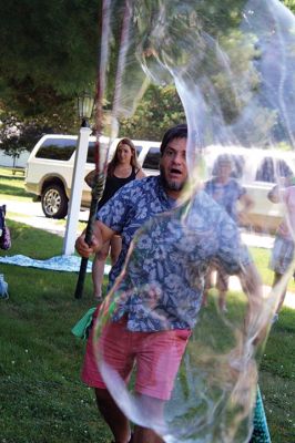 Keeping it cool
Kids gathered outside the Joseph H. Plumb Memorial Library on Friday, July 21, chilling in the shade drenched in bubble stuff with Vinny the Bubble Guy. Photos by Jean Perry
