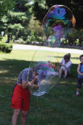 Keeping it cool
Kids gathered outside the Joseph H. Plumb Memorial Library on Friday, July 21, chilling in the shade drenched in bubble stuff with Vinny the Bubble Guy. Photos by Jean Perry
