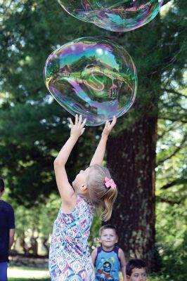 Keeping it cool
Kids gathered outside the Joseph H. Plumb Memorial Library on Friday, July 21, chilling in the shade drenched in bubble stuff with Vinny the Bubble Guy. Photos by Jean Perry
