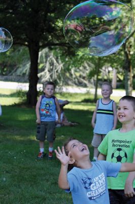 Keeping it cool
Kids gathered outside the Joseph H. Plumb Memorial Library on Friday, July 21, chilling in the shade drenched in bubble stuff with Vinny the Bubble Guy. Photos by Jean Perry
