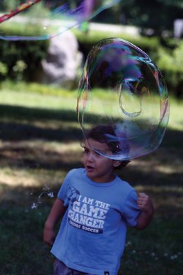 Keeping it cool
Kids gathered outside the Joseph H. Plumb Memorial Library on Friday, July 21, chilling in the shade drenched in bubble stuff with Vinny the Bubble Guy. Photos by Jean Perry
