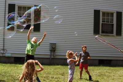 Keeping it cool
Kids gathered outside the Joseph H. Plumb Memorial Library on Friday, July 21, chilling in the shade drenched in bubble stuff with Vinny the Bubble Guy. Photos by Jean Perry
