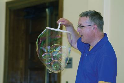 Bubbles, bubbles, everywhere! 
Kids were spellbound by Keith Johnson and his “Bubbleology” show at the Marion Music Hall on June 22, sponsored by the Elizabeth Taber Library. Ty Mackenzie, 9, was the lucky one who got to be swallowed up by a giant bubble. Photos by Jean Perry
