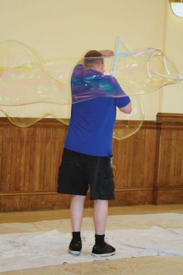 Bubbles, bubbles, everywhere! 
Kids were spellbound by Keith Johnson and his “Bubbleology” show at the Marion Music Hall on June 22, sponsored by the Elizabeth Taber Library. Ty Mackenzie, 9, was the lucky one who got to be swallowed up by a giant bubble. Photos by Jean Perry
