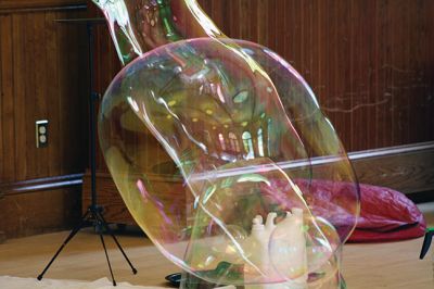 Bubbles, bubbles, everywhere! 
Kids were spellbound by Keith Johnson and his “Bubbleology” show at the Marion Music Hall on June 22, sponsored by the Elizabeth Taber Library. Ty Mackenzie, 9, was the lucky one who got to be swallowed up by a giant bubble. Photos by Jean Perry
