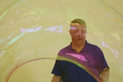 Bubbles, bubbles, everywhere! 
Kids were spellbound by Keith Johnson and his “Bubbleology” show at the Marion Music Hall on June 22, sponsored by the Elizabeth Taber Library. Ty Mackenzie, 9, was the lucky one who got to be swallowed up by a giant bubble. Photos by Jean Perry
