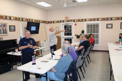 CPR Class
May Caron, 19, of Marion demonstrates a sound CPR form on a manikin, while New Bedford EMS trainer David Branco explains the practice during a September 21 class held at the Rochester Senior Center under the direction of the Rochester Fire Department. Branco and David Zander also demonstrated the use of a battery-operated, $15,000 CPR machine that last month was used during a cardiac event to save the life of Rochester Fire Chief Scott Weigel
