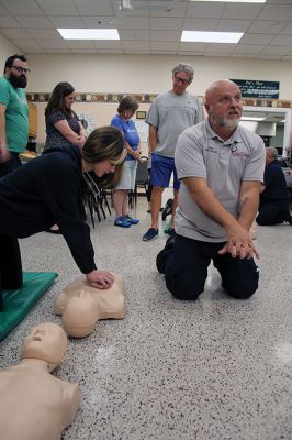 CPR Class
May Caron, 19, of Marion demonstrates a sound CPR form on a manikin, while New Bedford EMS trainer David Branco explains the practice during a September 21 class held at the Rochester Senior Center under the direction of the Rochester Fire Department. Branco and David Zander also demonstrated the use of a battery-operated, $15,000 CPR machine that last month was used during a cardiac event to save the life of Rochester Fire Chief Scott Weigel
