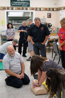 CPR Class
May Caron, 19, of Marion demonstrates a sound CPR form on a manikin, while New Bedford EMS trainer David Branco explains the practice during a September 21 class held at the Rochester Senior Center under the direction of the Rochester Fire Department. Branco and David Zander also demonstrated the use of a battery-operated, $15,000 CPR machine that last month was used during a cardiac event to save the life of Rochester Fire Chief Scott Weigel
