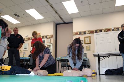 CPR Class
May Caron, 19, of Marion demonstrates a sound CPR form on a manikin, while New Bedford EMS trainer David Branco explains the practice during a September 21 class held at the Rochester Senior Center under the direction of the Rochester Fire Department. Branco and David Zander also demonstrated the use of a battery-operated, $15,000 CPR machine that last month was used during a cardiac event to save the life of Rochester Fire Chief Scott Weigel
