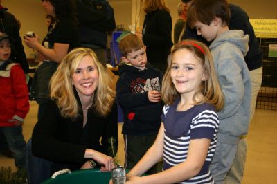 Earth Day
Elizabeth Richardson (left), of the Mattapoisett Land Trust, helps 2nd Grader Rosemary Loer with the materials to plant a Douglas Fir tree at Center School's First Annual Earth Day Celebration. Photo by Adam Silva
