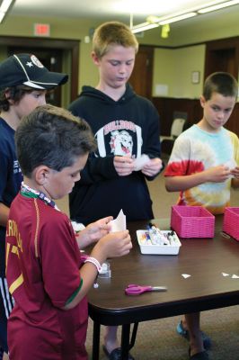 CSI Chemistry
During the CSI Chemistry event at the Mattapoisett Free Library on August 1, Rochester Police Chief Paul Magee fingerprinted the kids during a fingerprinting demonstration, and Brendan Taylor, age 10, was the first one up. Chief Magee’s son Rob Magee led the presentation, which was one of the library’s exciting children’s summer events. Photo by Jean Perry
