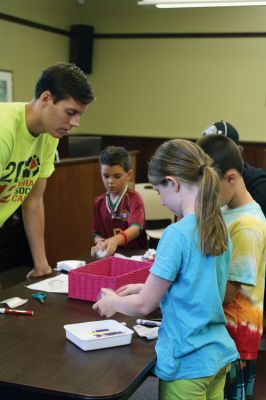 CSI Chemistry
During the CSI Chemistry event at the Mattapoisett Free Library on August 1, Rochester Police Chief Paul Magee fingerprinted the kids during a fingerprinting demonstration, and Brendan Taylor, age 10, was the first one up. Chief Magee’s son Rob Magee led the presentation, which was one of the library’s exciting children’s summer events. Photo by Jean Perry
