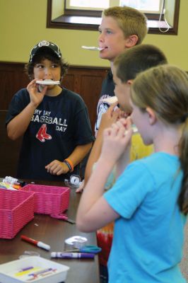 CSI Chemistry
During the CSI Chemistry event at the Mattapoisett Free Library on August 1, Rochester Police Chief Paul Magee fingerprinted the kids during a fingerprinting demonstration, and Brendan Taylor, age 10, was the first one up. Chief Magee’s son Rob Magee led the presentation, which was one of the library’s exciting children’s summer events. Photo by Jean Perry
