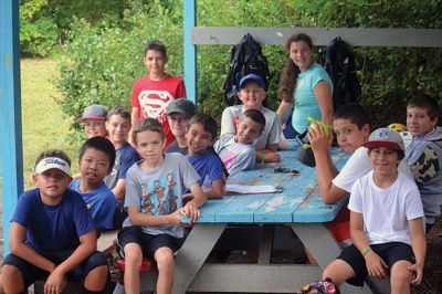 Happy Campers 
What's happening on a Tuesday morning at Camp Massasoit? It’s easier to ask what's not going on – swimming, boating, archery, crafts, exploring, wall climbing, ball playing, and that's all before they even break for lunch. Photos by Jonathan Comey
