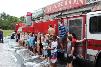 Sippican Elementary Car Wash
Sippican Elementary sixth graders turned Saturday's car wash into a fire engine wash, creating a waterfall of suds and having the kind of fun kids normally associate with what happens on the weekends before school is back in session. Organized by Volunteers at Sippican Elementary (VASE), the school's 501(c)(3) non-profit parent-teacher organization, the event held at the Marion school's bus loop off Main Street raised money for the students' mountain classroom trip, a three-day excursion planned for June 20
