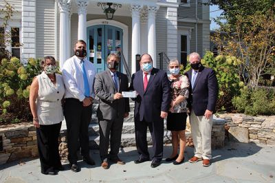 CARES Act 
From left, Marion Finance Director Judy Mooney, Town Administrator Jay McGrail, Board of Selectman Chairperson Randy Parker, Plymouth County Treasurer Thomas O’Brien, County Commissioner Sandra Wright, and County Commissioner Greg Hanley were at the steps of Taber Library on Friday for the presentation of the first CARES Act reimbursement check and a framed map of Marion. Photos by Mick Colageo
