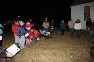 Tinkhamtown Chapel Christmas Carol Singalong
Sunday's participants in the Tinkhamtown Chapel Christmas Carol Singalong braved a dramatic, postsunset drop in temperature and enjoyed the warmth of a solo bonfire loaned to the event by Lee Heald. Gail Roberts led distributed sheet music and led in song with musicians Louise Anthony playing the fiddle and Jack Dean the ukulele. Roberts thanked the White family for providing refreshments, the Chapel committee for its effort in maintaining the chapel 
