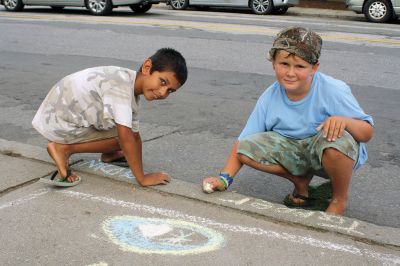 Chalk It Up
The day before the Marion Town Party, kids chalked-up the sidewalks in front of the Marion Town House in preparation for the Saturday night event. Town Party Planning Committee members set up picnic tables and strung party lights in the background while the kids drew colorful, festive pictures with chalk. Photos by Jean Perry
