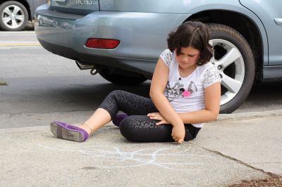 Chalk It Up
The day before the Marion Town Party, kids chalked-up the sidewalks in front of the Marion Town House in preparation for the Saturday night event. Town Party Planning Committee members set up picnic tables and strung party lights in the background while the kids drew colorful, festive pictures with chalk. Photos by Jean Perry
