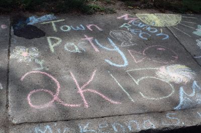 Chalk It Up
The day before the Marion Town Party, kids chalked-up the sidewalks in front of the Marion Town House in preparation for the Saturday night event. Town Party Planning Committee members set up picnic tables and strung party lights in the background while the kids drew colorful, festive pictures with chalk. Photos by Jean Perry
