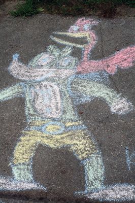 Chalk It Up
The day before the Marion Town Party, kids chalked-up the sidewalks in front of the Marion Town House in preparation for the Saturday night event. Town Party Planning Committee members set up picnic tables and strung party lights in the background while the kids drew colorful, festive pictures with chalk. Photos by Jean Perry
