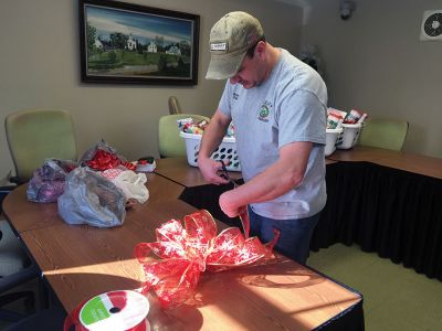 Christmas Baskets
On Tuesday, December 20, Rochester Facilities Manager Andrew Daniel was tying perfect Christmas bows to top off gift baskets for Rochester families purchased with donations from Town Hall staff and town boards and committees. Four families this year will receive a Christmas meal in a basket thanks to the efforts of all at Town Hall. Altogether $1,400 was raised at Town Hall, with half going to the gift baskets and the other half towards other town Christmas charities. Photos by Jean Perry
