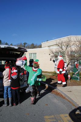 Fill-A-Cruiser Toy Drive
Sunday’s Fill-A-Cruiser toy drive at Sippican Elementary School was a success! Volunteers representing the Marion Police Department, Police Brotherhood, and Sippican School (VASE) welcomed a parade of vehicles of families dropping off a variety of Christmas gifts for cookies and cupcakes. Marion Police Chief John Garcia donned the Santa suit and took pictures with kids in school resource officer Matt McGraw’s 1924 Ford Model-T. Photos by Mick Colageo
