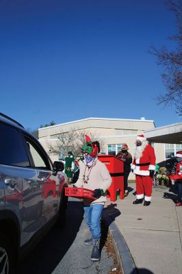 Fill-A-Cruiser Toy Drive
Sunday’s Fill-A-Cruiser toy drive at Sippican Elementary School was a success! Volunteers representing the Marion Police Department, Police Brotherhood, and Sippican School (VASE) welcomed a parade of vehicles of families dropping off a variety of Christmas gifts for cookies and cupcakes. Marion Police Chief John Garcia donned the Santa suit and took pictures with kids in school resource officer Matt McGraw’s 1924 Ford Model-T. Photos by Mick Colageo
