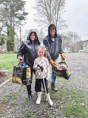 Mattapoisett Sustainability Partnership
Dakota, Lynne and Drew Nahigyan, below, were dressed for the rain and used recycled bags to clean up a street in the eastern part of town.
