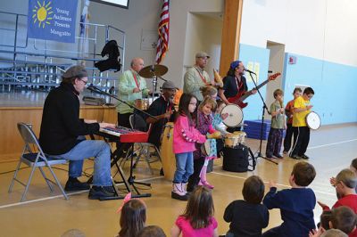 Manguito
Center School students were introduced to Latin rhythms and percussion instruments by the Boston-based educational Latin American music group Manguito during an afternoon presentation on January 24. Manguito members really captured the attention of the kids, resulting in plenty of learning while the group’s sizzling salsa and merengue music resulted in an eruption of dancing and spontaneous conga lines. Photo by Jean Perry
