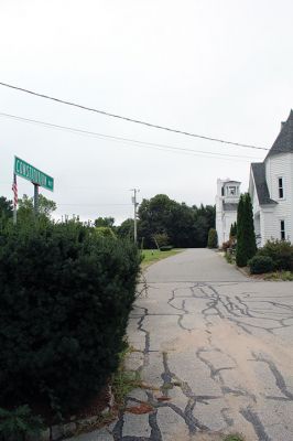 Constitution Way
For many years, Constitution Way has given Rochester village a stately presence as Town Hall, the meeting house, and First Congregational Church sit on the same parallel, but the emerging danger of eastbound traffic speeding down Rounseville Road and using Constitution Way as an exit ramp is endangering people exiting the buildings because there is no buffer between the last step of those buildings and the roadway. In a special meeting with the Public Safety Committee and the Emergency Planning Committee he
