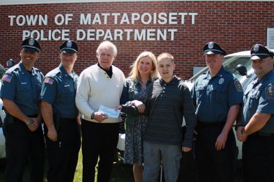 Cops for Kids
On April 28, Nicholas Claudio and his mother Alison Isherwood received a ‘big check’ for $5,000 from a partnership between Cops for Kids with Cancer and the Mattapoisett Police Officer’s Association. Claudio is a sophomore at ORRHS, an honor role student, and a cancer survivor. From Left to Right: Officers Adalbert Cardoso and Nicholas Lorenco, Cops for Kids with Cancer Chairman Robert Faherty, Mom Alison Isherwood, Nick Claudio, and Officers Turner Ryan and Kyle Pavao. Photos by Marilou Newell
