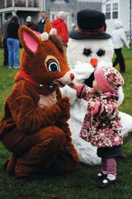 Babes in Toyland
Mattapoisett held its annual holiday celebration and tree lighting on Saturday, December 5, 2009 at Shipyard Park. The rain couldn't dampen holiday spirits as visitors enjoyed delicious food and listened to Christmas music performed by the Showstoppers. Children made their own ornaments and hung them on the Christmas tree. They also danced with Rudolph and Frosty and shared their Christmas wishes with Santa Claus. Photo by Felix Perez.
