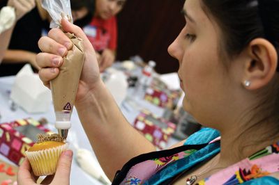 Cupcake Decorating
Mattie Boyle demonstrates proper cupcake frosting technique using a variety of piping bag tip.  Photo by Eric Tripoli.
