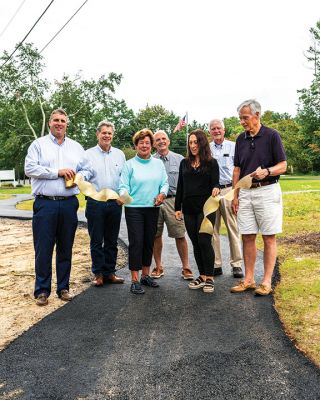 Marion Council on Aging
Merry Conway, president of the Friends of the Marion Council on Aging, cuts the ribbon officially opening the new Walking Path at the Cushing Community Center on September 24. From left: Town Administrator Jay McGrail, Select Board member Randy Parker, Merry Conway, COA Chair Harry Norweb, Administrative Assistant Donna Hemphill, Select Board Chair Norm Hills, and Community Preservation Committee Chair Jeff Doubrava. Photos by Ryan Feeney
