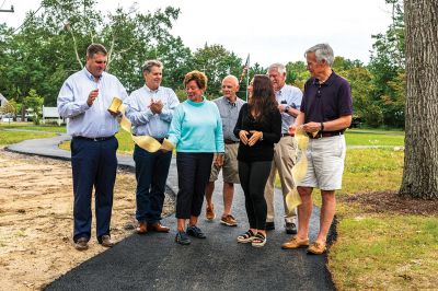 Marion Council on Aging
Merry Conway, president of the Friends of the Marion Council on Aging, cuts the ribbon officially opening the new Walking Path at the Cushing Community Center on September 24. From left: Town Administrator Jay McGrail, Select Board member Randy Parker, Merry Conway, COA Chair Harry Norweb, Administrative Assistant Donna Hemphill, Select Board Chair Norm Hills, and Community Preservation Committee Chair Jeff Doubrava. Photos by Ryan Feeney
