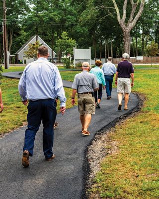 Marion Council on Aging
Merry Conway, president of the Friends of the Marion Council on Aging, cuts the ribbon officially opening the new Walking Path at the Cushing Community Center on September 24. From left: Town Administrator Jay McGrail, Select Board member Randy Parker, Merry Conway, COA Chair Harry Norweb, Administrative Assistant Donna Hemphill, Select Board Chair Norm Hills, and Community Preservation Committee Chair Jeff Doubrava. Photos by Ryan Feeney
