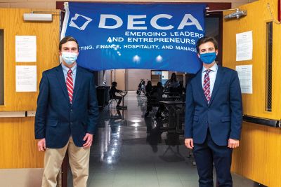 ORR DECA
The DECA program at Old Rochester Regional High School is growing by leaps and bounds, and award recipients in the regional competition gathered on January 29 for a socially distanced group photo in the gymnasium followed by an awards ceremony in the cafeteria. Chapter Co-Presidents Teddy Carroll (left) and Eddie Gonet stand under the DECA banner, and Gonet welcomed the attendees. Photos by Ryan Feeney
