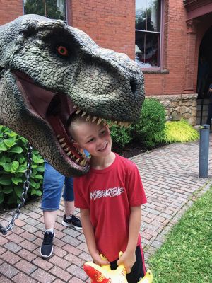 Summer Reading Program
As a kickoff to the summer reading program at the Elizabeth Taber Library and summer Natural History Museum programming, the Town of Marion was treated to a visit from a full-size whale, two very large dinosaurs and one baby dino named Spike. The Summer Block Party event held on June 24 started inside the Music Hall due to weather but later moved outside. The event also featured faux archeology digs and face painting. Photos by Marilou Newell - June 29, 2023 edition
