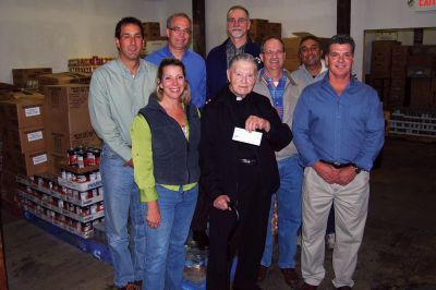 Road Race Fundraising
The Rochester Road Race would like to thank the 444 runners and walkers who participated in the 2009 Race for helping to ensure that fewer local families go hungry this holiday season. On Tuesday, October 6, the Road Race Board presented a check for $4,000 to Father Gabriel Healy, Director and Treasurer of Damiens Place Food Pantry in Wareham. 
