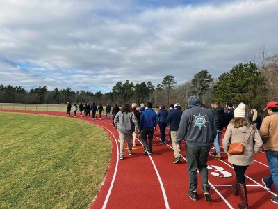 Dana Dourdeville
Family, friends, teachers, coaches, classmates and community members gathered to walk a mile in remembrance and celebration of Dana Dourdeville's life on New Year's Eve, the 10th anniversary of his passing. They honored the valedictorian, all-star track athlete and beloved member of the Tri-Town community with a moment of silence and by tying colored ribbons on a tree in his memorial garden at the track at Old Rochester Regional High School, also recognizing and celebrating his kindness and humility above a
