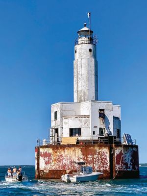 Cleveland Ledge Lighthouse
Painting crew on the Cleveland Ledge Lighthouse, waving away dangerously close boaters. Photo by Mary Dermody
