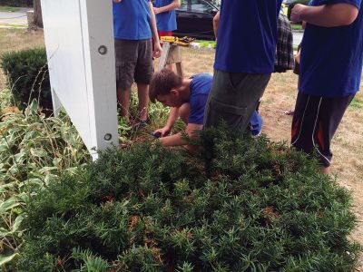 Boy Scout Troop 53
James DeMailly, a Mattapoisett resident with Boy Scout Troop 53, works along with fellow troop members to complete his Eagle project on Saturday, August 13. DeMailly repaired, restored, and coordinated the re-installation of the Mattapoisett Congregational Church sign with troop assistance. DeMailly said the scope of work took several months, as refurbishment was fairly extensive. The church funded the project. Photo by Marilou Newell
