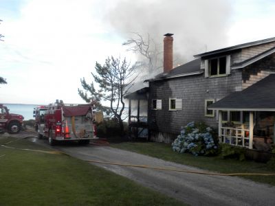 Bay Road Fire
The Mattapoisett Fire Department responded to a house fire on Bay Road at Point Connett around 7pm on Thursday July 22, 2010. The front of the structure was heavily damaged but the Fire Department was able to quickly contain the fire and keep it from spreading to neighboring homes. Photo by Paul Lopes
